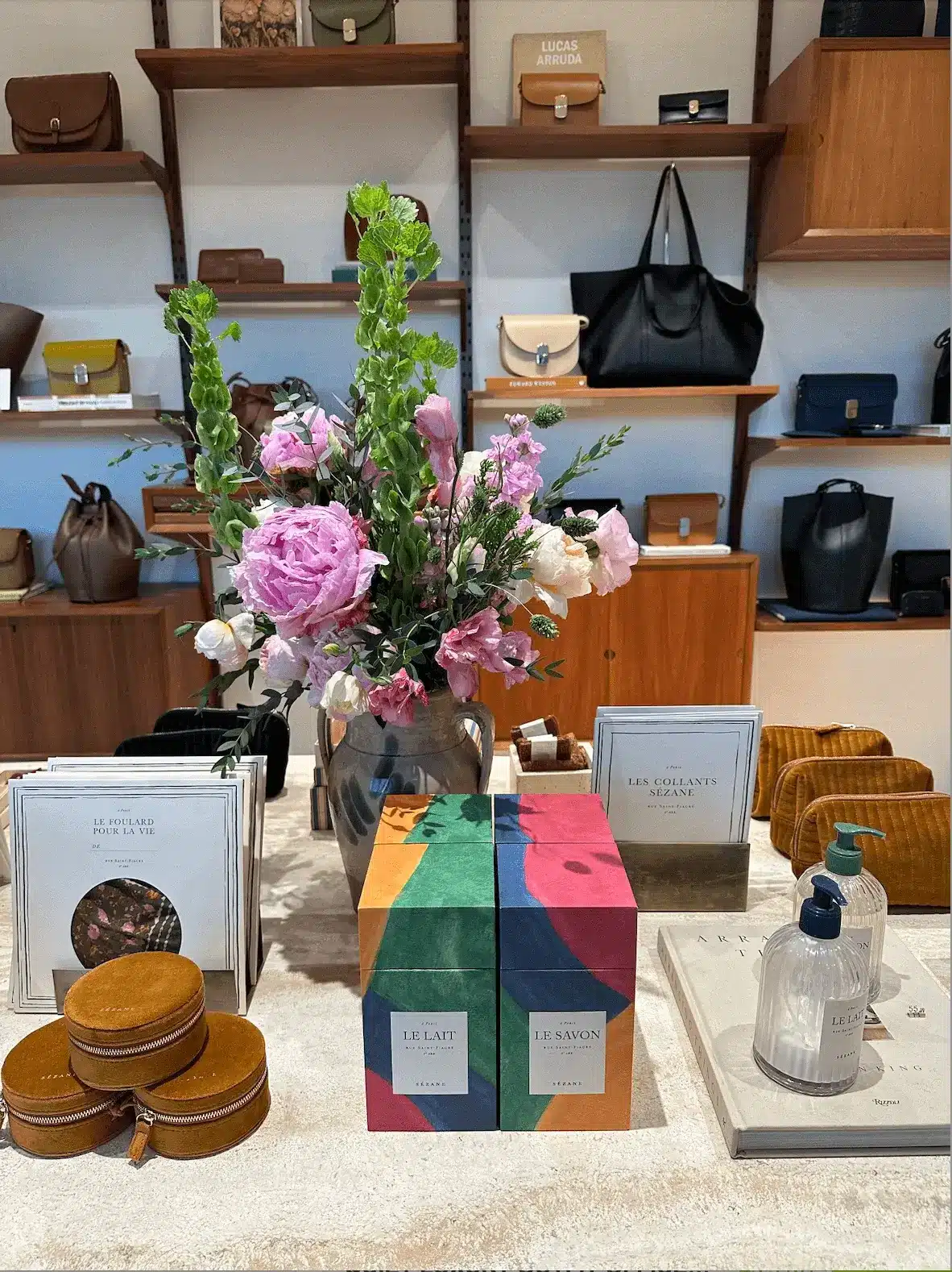 sezane store interior featuring purses and candles