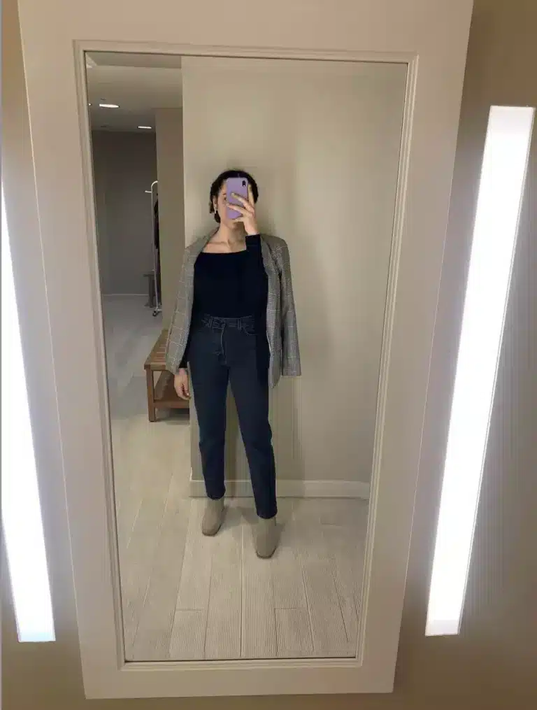 woman in blazer and dark jeans outfit