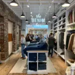 Inside of a Madewell retail store showing denim and shoppers - brands like everlane