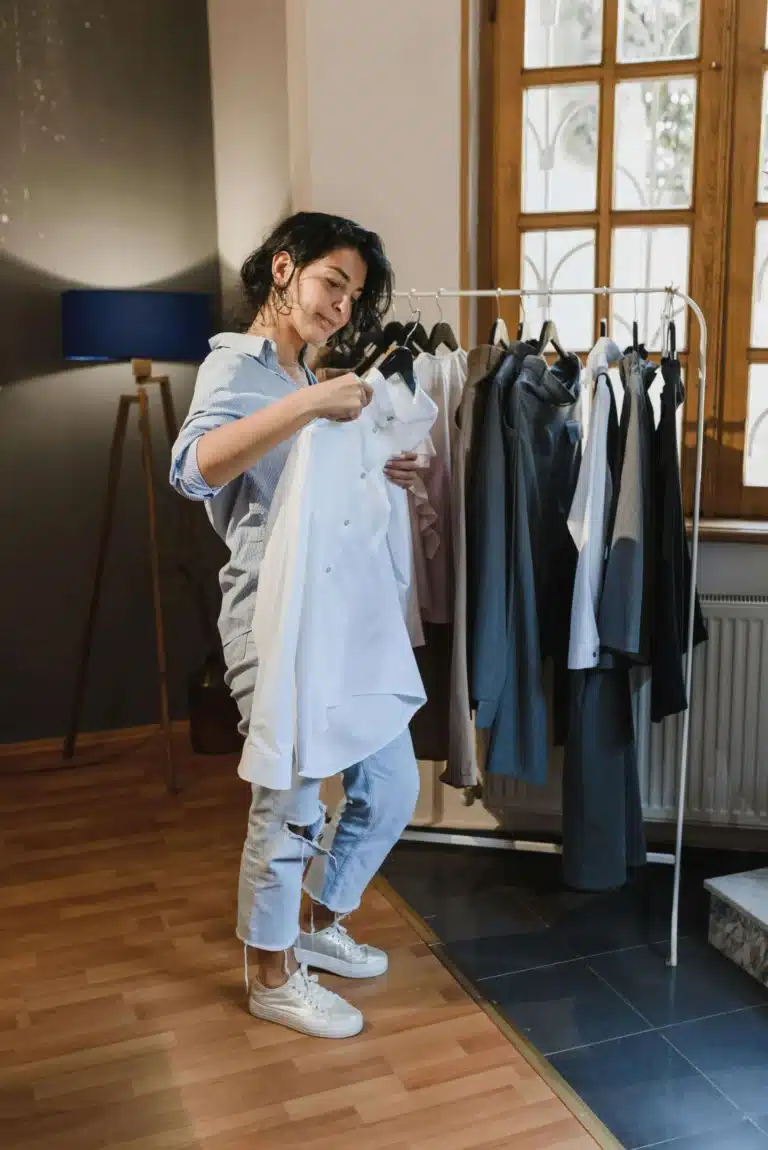 woman sorting through minimalist closet