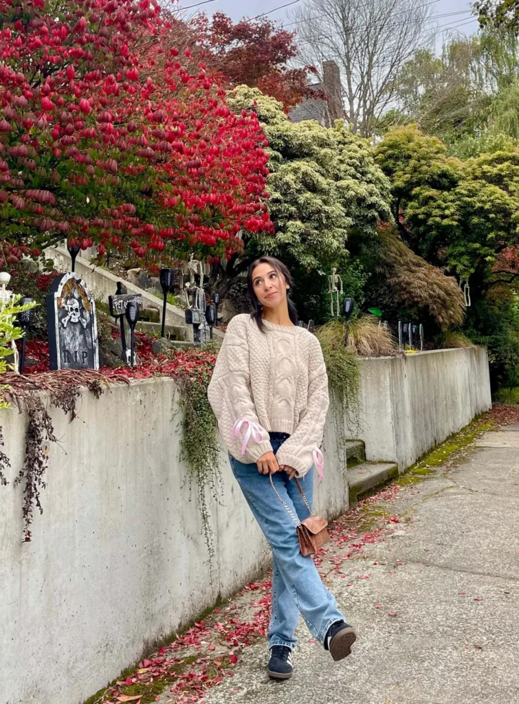 Bow sweater outfit with jeans and adidas sambas