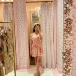 woman in pink mini LoveShackFancy coquette dress