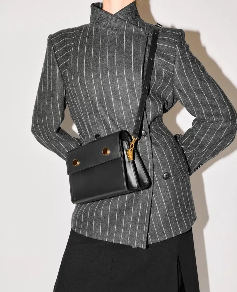 Smooth Grain Leather Bag worn crossbody over a pinstriped blazer