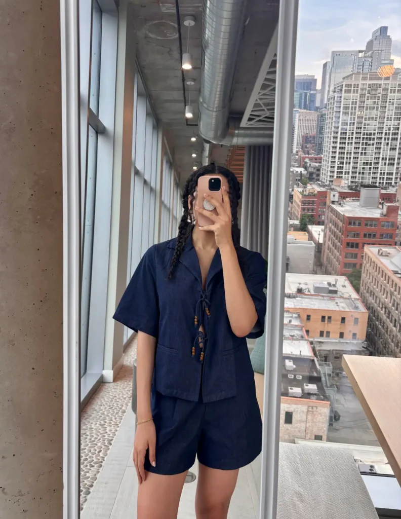 Woman in monochrome navy blue outfit with tailored shorts and collared v neck top
