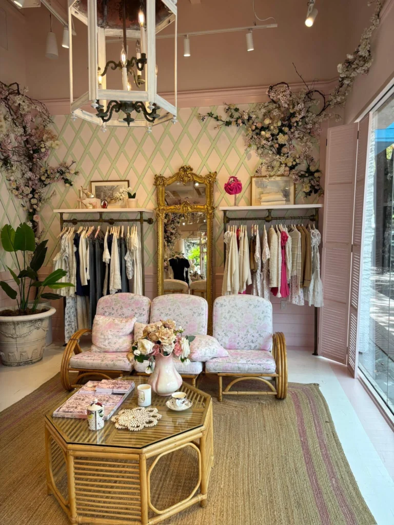 Love Shack Fancy Store with dresses hangigni and wicker chairs