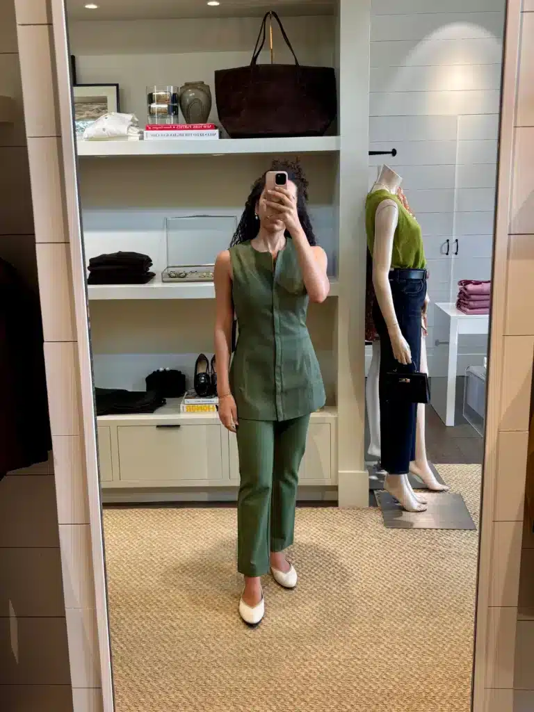 Woman in green Tuckernuck work Outfit inside store