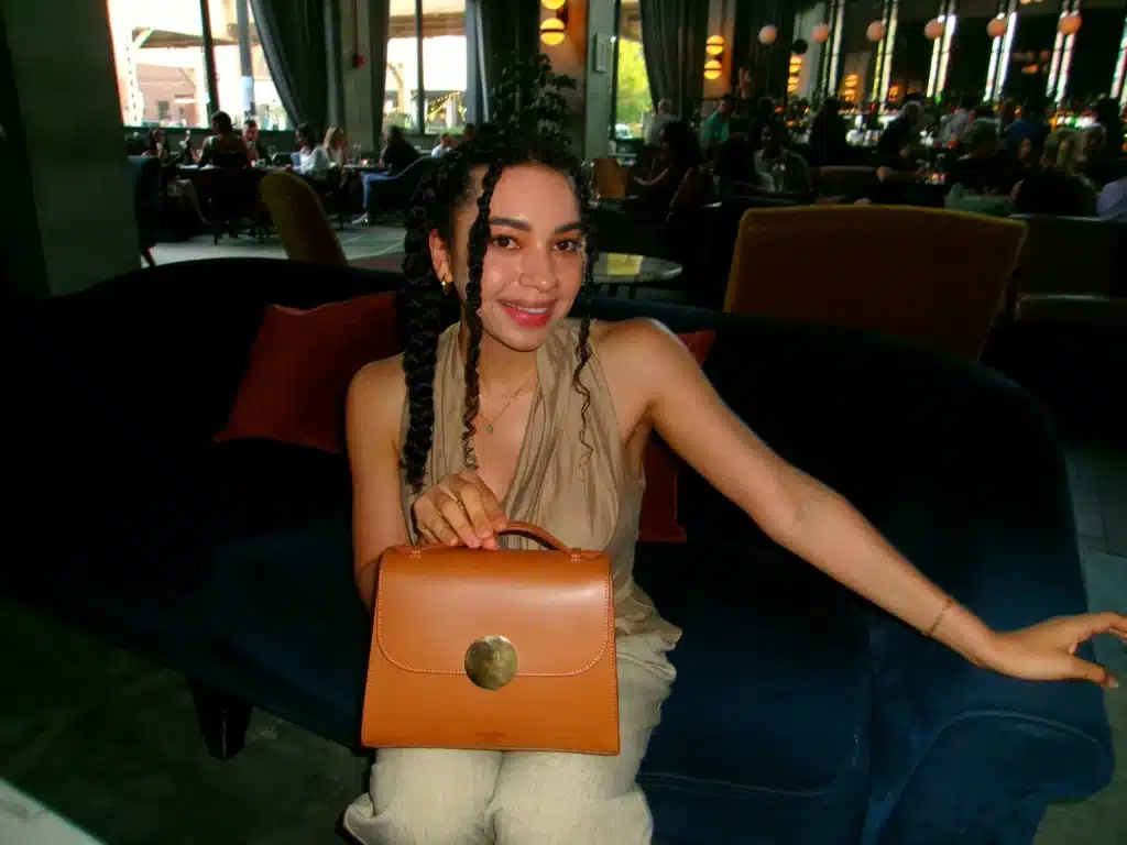 Woman with LeParmentier bag in hotel lobby