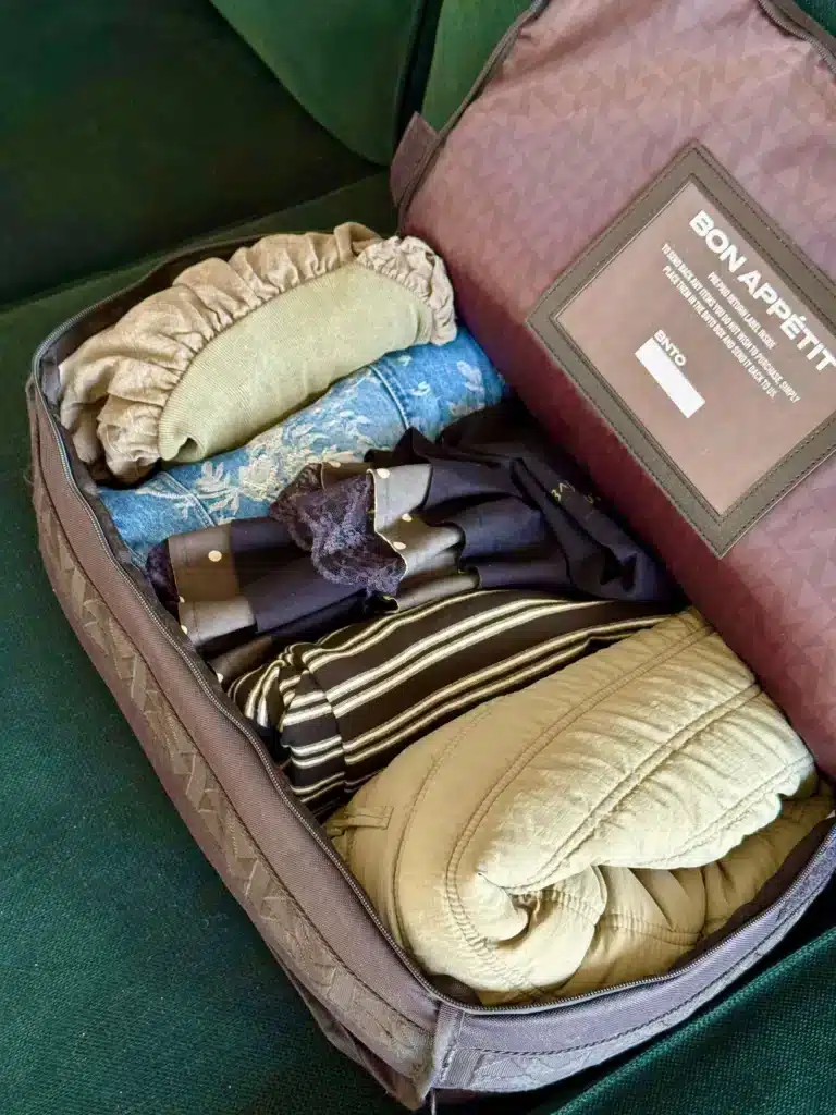 BNTO clothing rental box showing clothes folded neatly