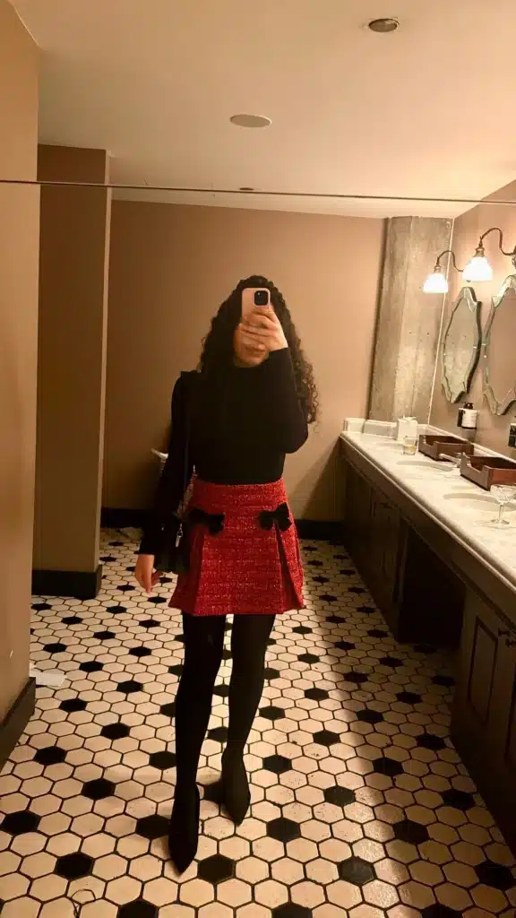 Woman in red mini skirt from BNTO, black turtleneck and black high heels