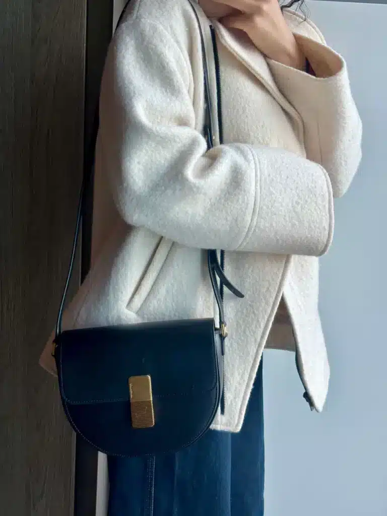 woman wearing leather august ateliers bag