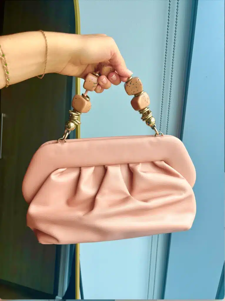THEMOIRè Stone Rose bag held in womans hand