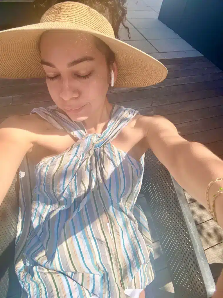 woman in sun visor and summer tank top