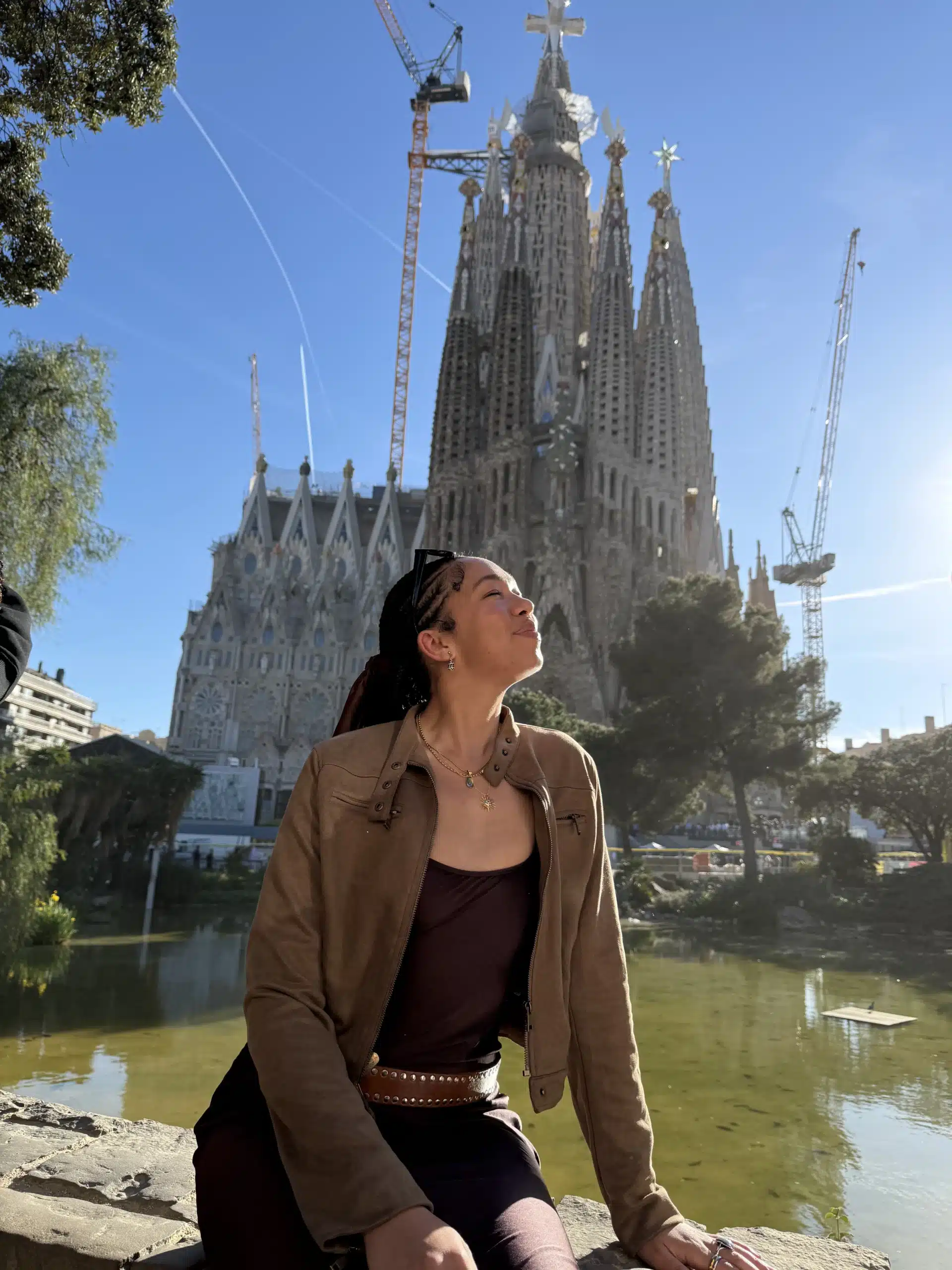 Nuuly review featuring woman in brown rented Lioness jacket in front of a cathedral