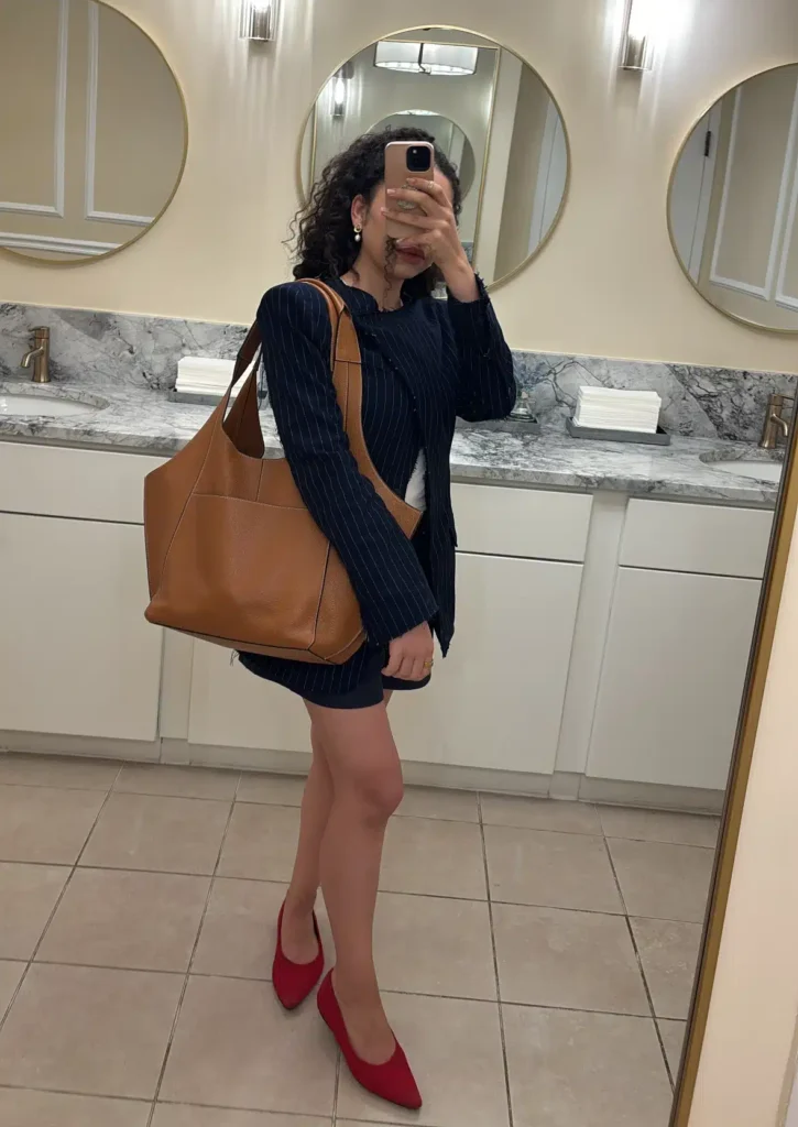 Woman with RSVP Paris Parachute Bag and red ballet flats