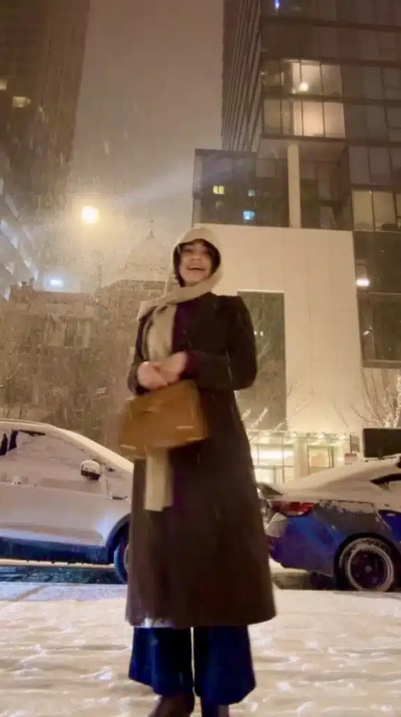 Woman in winter coat during snow