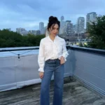 Woman on rooftop wearing natural fiber cotton blouse