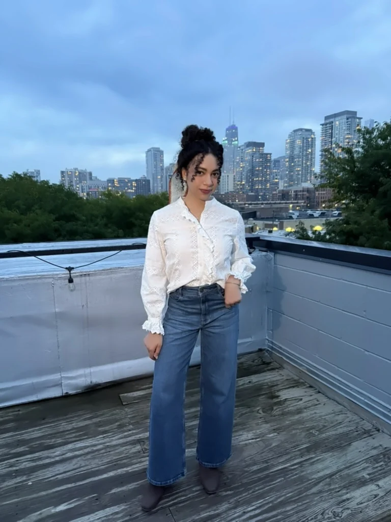 Woman on rooftop wearing natural fiber cotton blouse