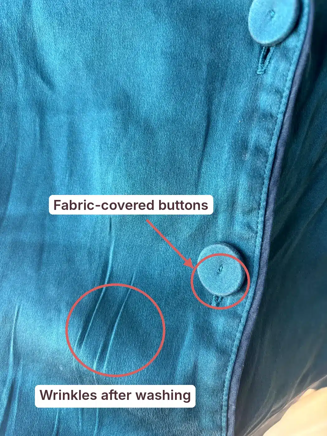 Lunya washable silk pajama top annotated to show fabric-covered buttons and wrinkles after washing