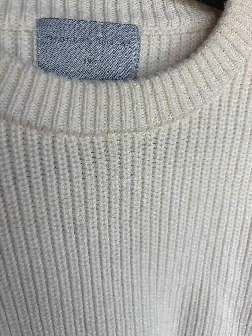 Close-up of the dense rib knit at a Modern Citizen sweater neckline