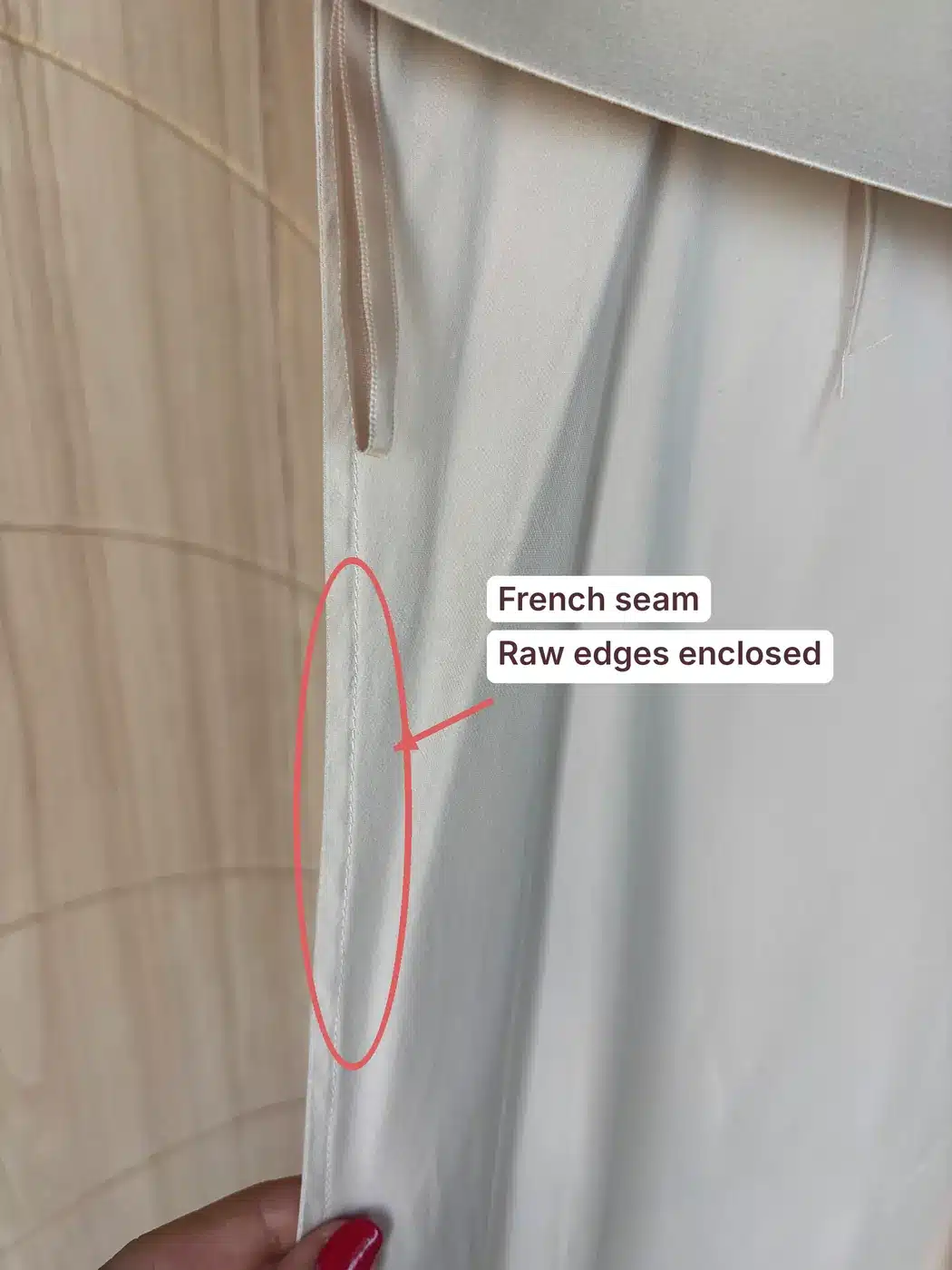 Inside of a Quince silk skirt with the French seam circled, showing the raw edges enclosed