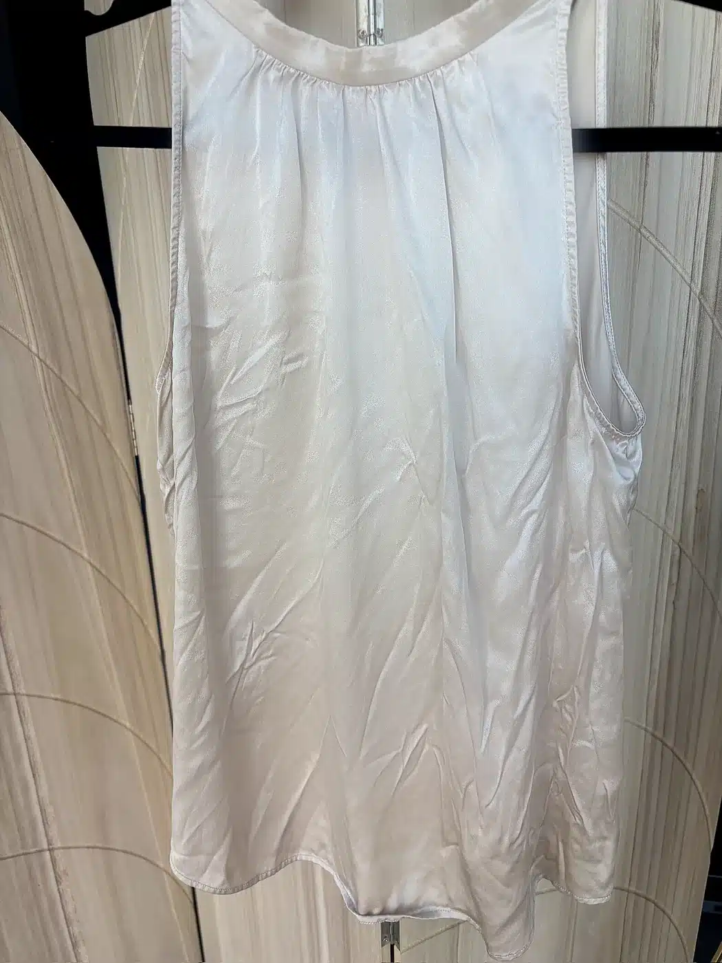 Champagne Quince washable silk halter top on a hanger