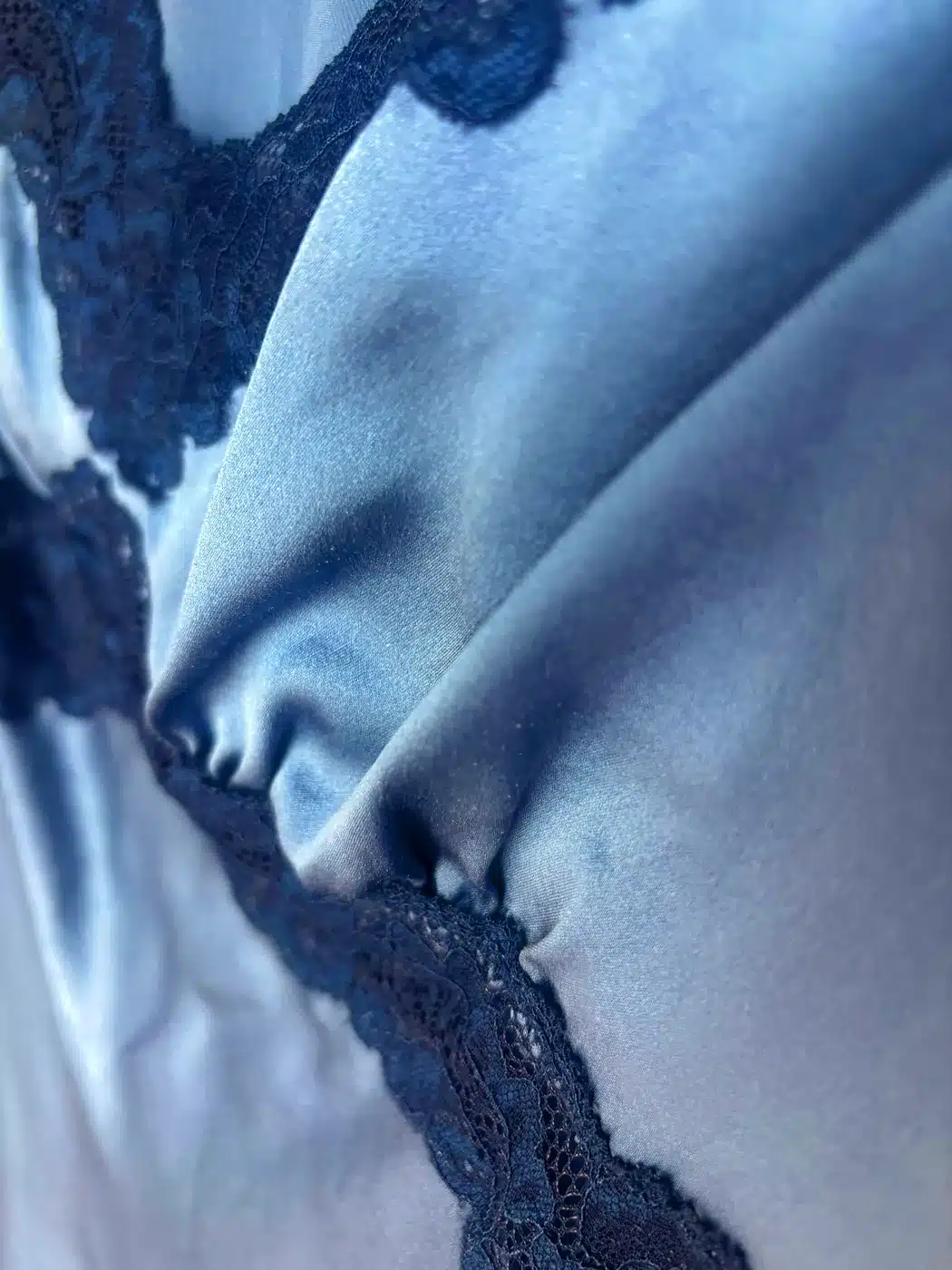 Blue Reformation Romi silk charmeuse dress with navy lace trim at the bodice
